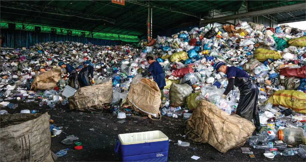 A group of men doing manual waste recycling